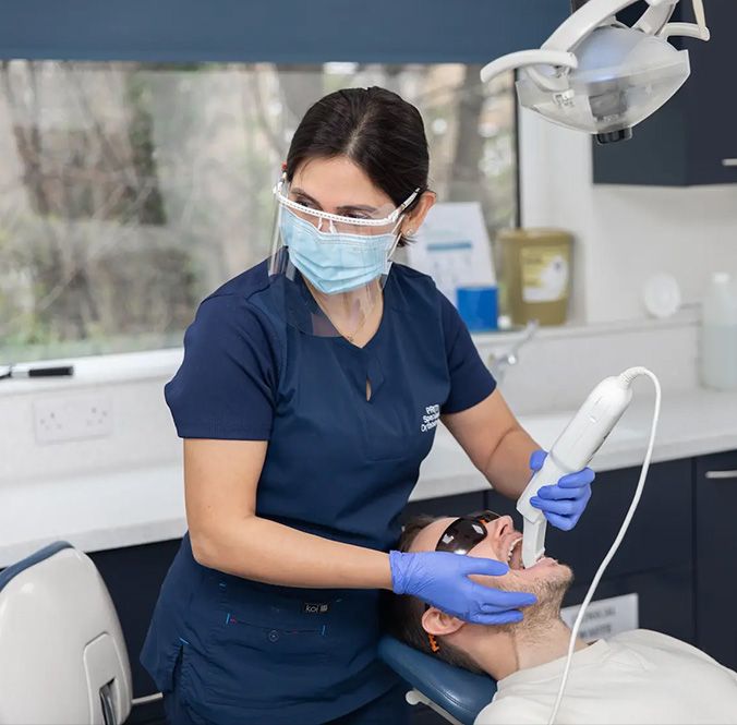 A clinician working with a patient at Ethicare Dental